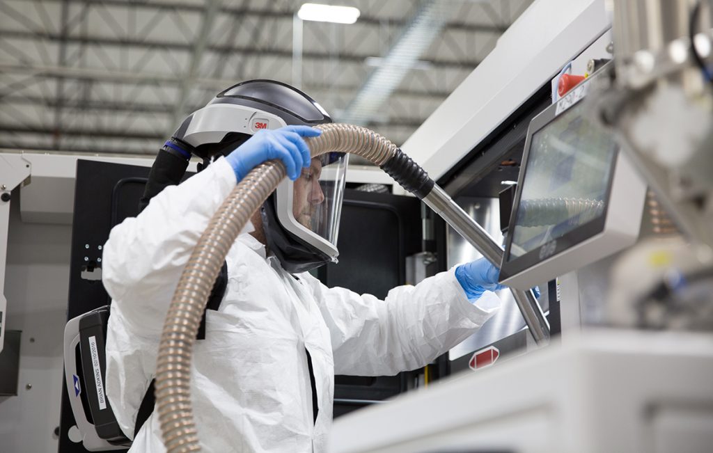 Fig. 7 An AM machine at CATA is vacuumed to salvage unused metal powder and prevent cross-contamination (Image: GE Reports/Chris New) [15]