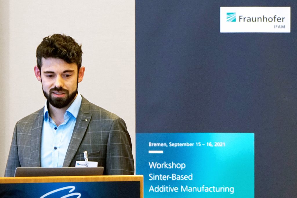 Fraunhofer IFAM's Bastian Barthel presented research on the relation of powder particle properties to parameters in the BJT manufacturing, curing and sintering processes