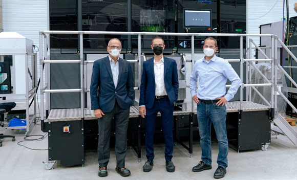 Andrea Scanavini, Chief Operating Officer, BEAMIT (centre) with GE Additive’s Fausto Asvisio (left) and Wolfgang Lauer (right) with an M Line at GE Additive Lichtenfels (Courtesy GE)