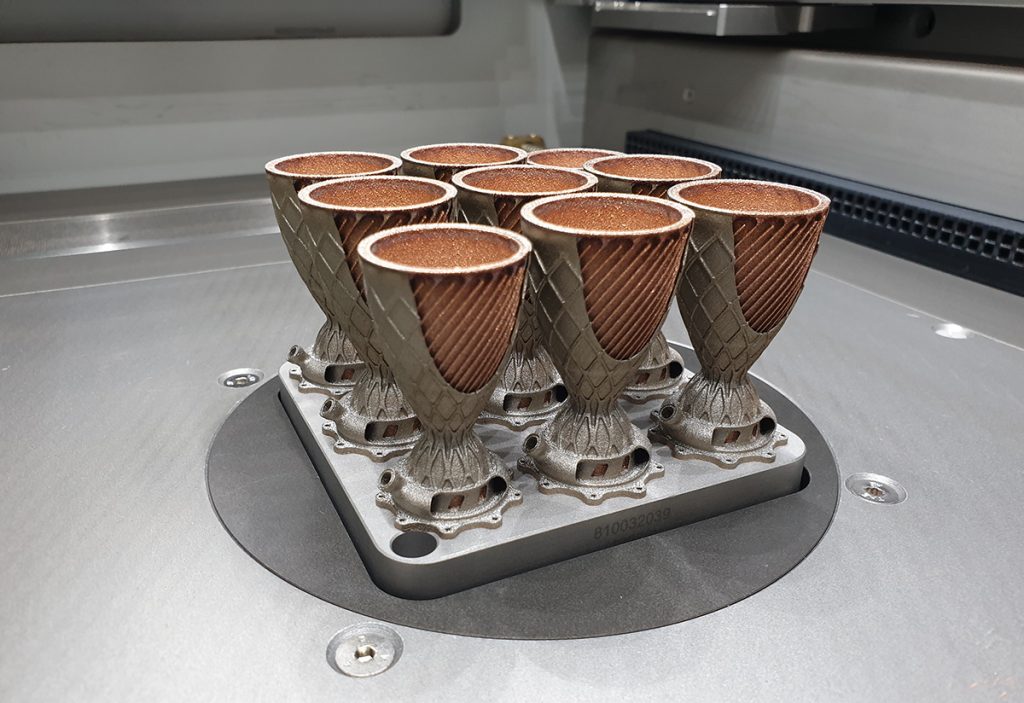 Fig. 1 Nickel-copper combustion chamber demonstrator parts on the build platform (Courtesy Fraunhofer IGCV)