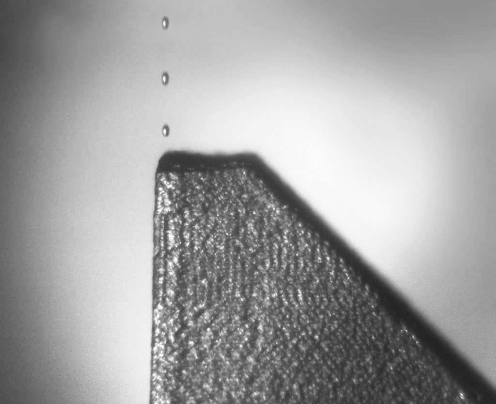 Fig. 3 An in-process image showing the release of multiple droplets of molten material (Courtesy Xerox)