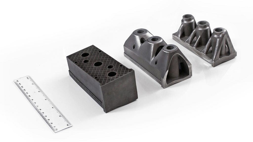 Fig. 4 A punch in an industrial production tool for the stamping of 1 mm thick hot-dip galvanised DP600 sheet. From left to right: the conventional design with a honeycomb inner structure, topology optimised with LS-TaSC, and topology optimised using Siemens NX12. All three punches are additively manufactured in maraging steel 1.2709 (Courtesy Nader Asnafi)