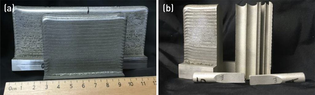 Fig. 7 Laser directed energy deposited samples (a) and machined to extract tensile specimen in a vertical orientation (b) [2]