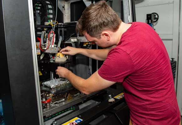 Dan Porter, a Xerox technician assembles a print head aboard the USS Essex (Courtesy U.S. Navy Petty Officer 3rd Class Isaak Martinez)