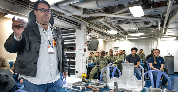 SPEE3D co-founder and CTO Steve Camilleri presenting metal 3D printed parts to the US Navy (Courtesy DVIDS/Jhon Parson)