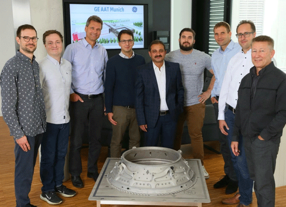 Right to left: Dr Hermann Scheugenflug, GE Aerospace; Dr Dirk Herzog, TUHH; Dr Andreas Peters, GE Aerospace; Nick Markovic, Autodesk; Ashish Sharma, GE Aerospace, Project Leader; Dr Andrea Milli, GE Aerospace; Dr Guenter Wilfert, GE Aerospace; Andy Harris, Autodesk; and Philipp Manger, Autodesk (Courtesy GE Additive/GE Aerospace)