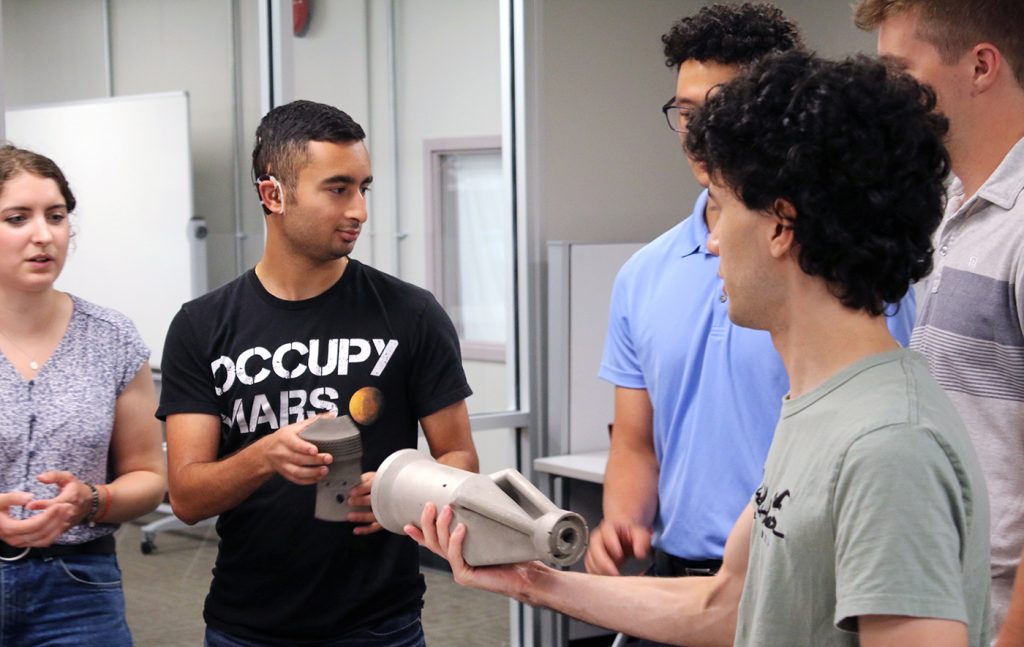 Fig. 1 Ohio State CDME staff and student researchers examine additively manufactured metal gas turbine components during a collaborative meeting with the Siemens Energy and Engie teams