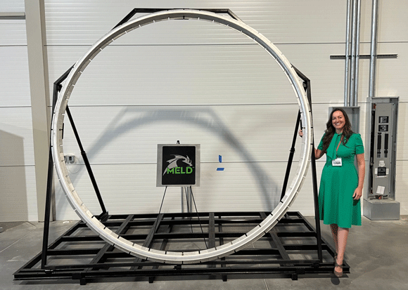 Nanci Hardwick, MELD CEO, with the 3D printed 3 m tall MELD deposited ring which was showcased at the facility ribbon-cutting ceremony (Courtesy MELD Manufacturing Corporation)