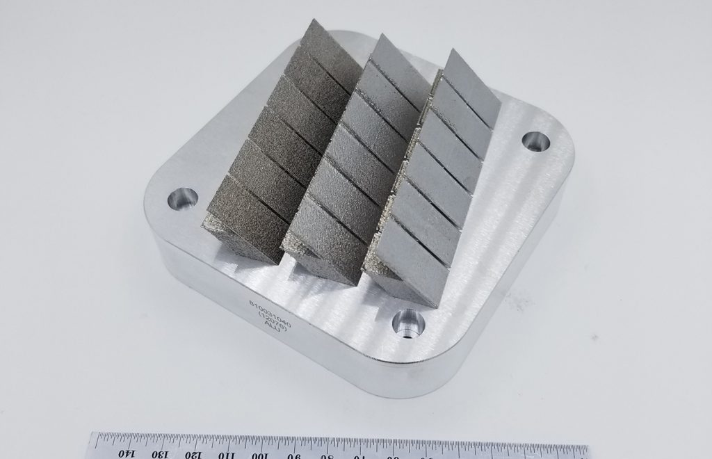 Fig. 10 A design of experiment combining wide cross sections with thin walls, overhanging, upskin, vertical and horizontal surfaces. Each surface is characterised for roughness and each feature is measured for geometric tolerance to feedback into the parameter optimisation cycle