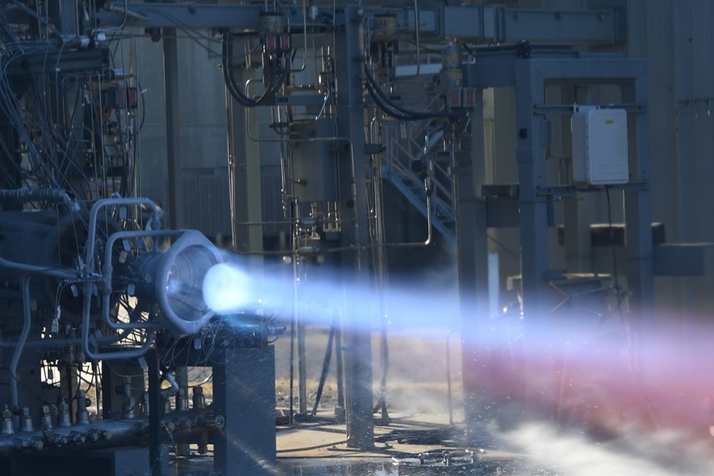 Fig. 12 Successful hot-fire test of an Additive Manufacturing thrust chamber including PBF-LB Alloy 718 injector, PBF-LB GRCop-42 chamber, and DED-LB/powder NASA HR-1 regeneratively-cooled nozzle under LLAMA (Courtesy NASA)