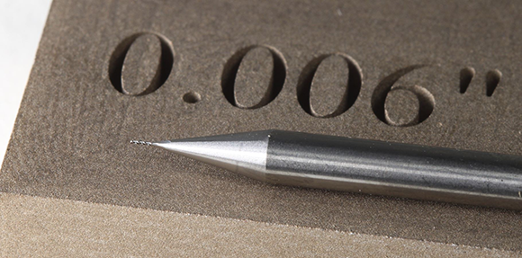 Photo showing the detail achievable using Mantle’s sinter-based metal Additive Manufacturing technology for tooling, with a 0.005” endmill for scale (Courtesy Mantle)