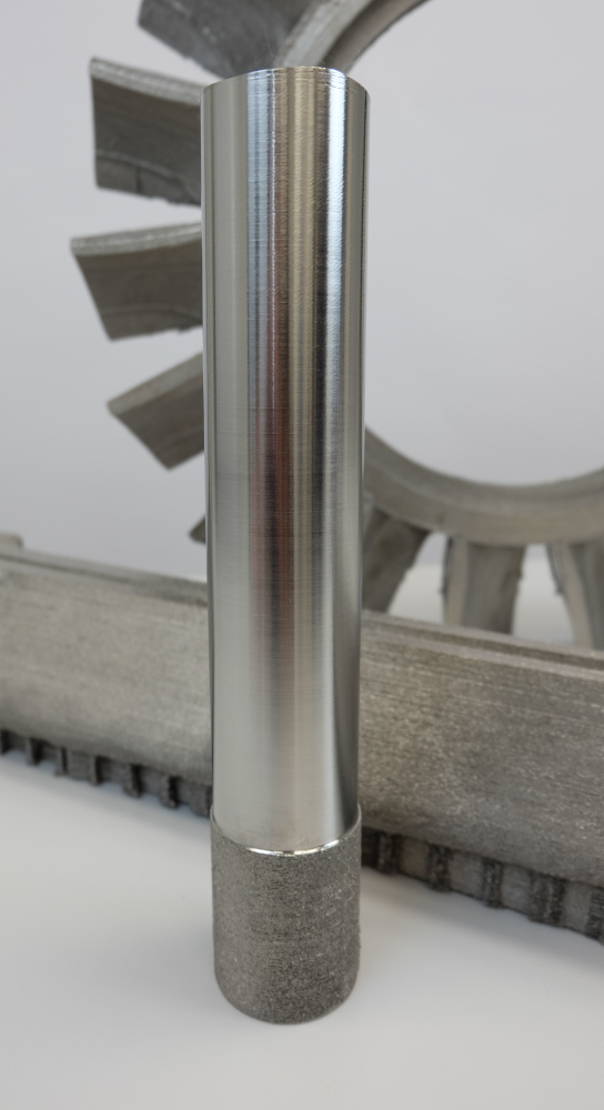 Fig. 8 Specimen (height 300 mm) built with highly-productive process parameters on ALD’s EBuild 850. Bottom as-built, and top, machined (Courtesy ALD Vacuum Technologies)
