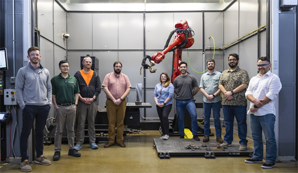 The ORNL team worked with industry partner Siemens to create a steam turbine blade, shown at the center of the image, using a wire arc Additive Manufacturing (Courtesy Carlos Jones/ORNL, U.S. Dept. of Energy)