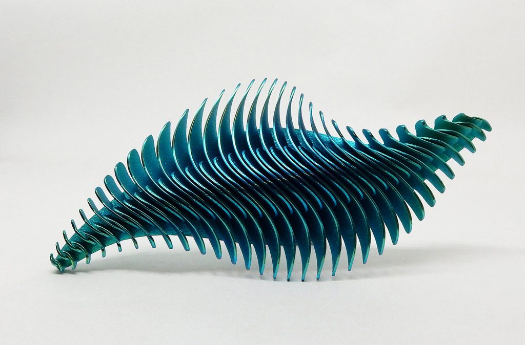 Fig. 5 'Vertebrae 158' brooch (2020), designed by Stefania Lucchetta. Materials are anodised titanium and steel. Laser Beam Powder Bed Fusion (PBF-LB)
was the primary technology used, and the piece is hand finished using sandblasting and polishing (Courtesy Stefania Lucchetta)