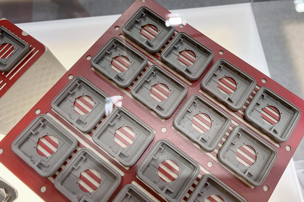 Fig. 13 Demonstration smartwatch cases produced on the Incus Hammer Pro40 machine. These parts are in the 'green', or un-sintered state. The MIM-like surface finish and resolution make this process highly attractive to producers of precision components who wish to minimise post-processing operations