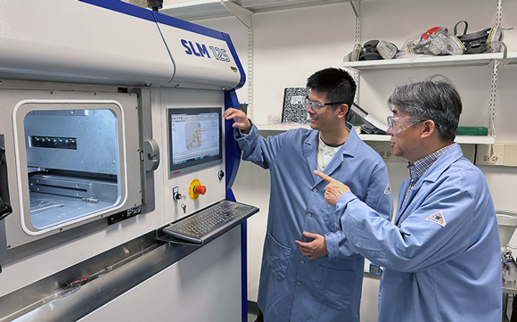 Purdue University professor Xinghang Zhang (right) and graduate research assistant Anyu Shang perform research using an Additive Manufacturing machine at the Flex Lab in Discovery Park District at Purdue (Courtesy Purdue University/Huan Li)