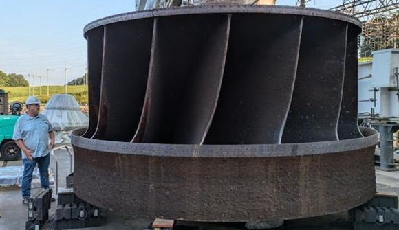ORNL’s Jay Tiley inspects a hydroelectric runner from TVA’s Cherokee Dam. ORNL is partnering with TVA and others to develop a process to produce large metal components like this for clean energy applications (Courtesy Jim Tobin/ORNL, US Dept. of Energy)
