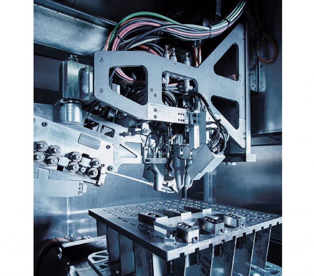 Fig. 2 Interior of one of Norsk Titanium's Merke IV machines with a build plate clamped in place (Courtesy Norsk Titanium)