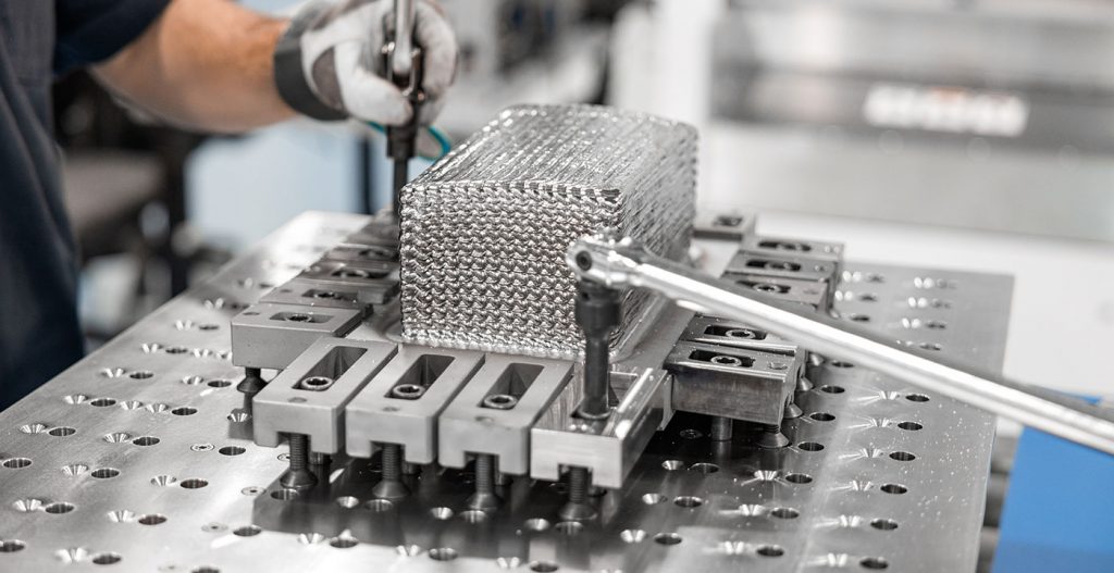 Fig. 11 An as-built 'loaf of bread' being removed from a Merke IV machine (Courtesy Norsk Titanium)