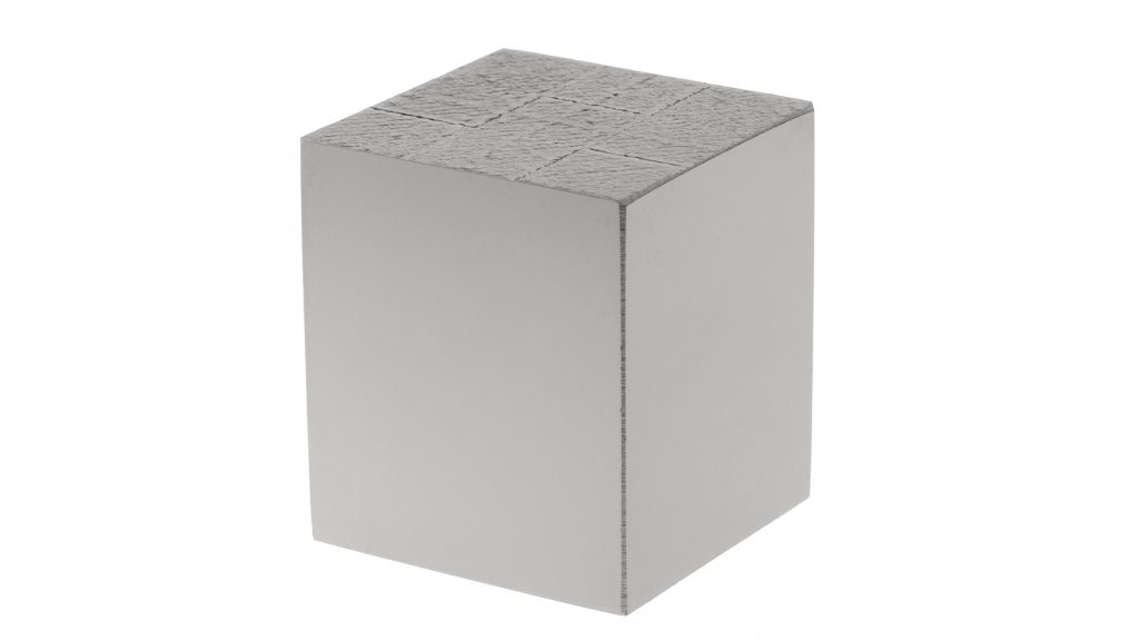 Fig. 11 Tungsten cube, 30 x 30 x 30 mm, built in Freemelt ONE®. The side surfaces have been polished afterwards and do not show any porosity or cracks. The density is estimated at >99.8% based on density measurements of similar cubes (Courtesy Freemelt)