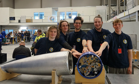The student preparation team in Kiruna, from left to right: Felix Oesterle, Nima Mirrafati, Felix Schoetzau, Matteo Grube, Arved Dörpinghaus in front of the experiment module and the rocket nose cone (Courtesy WOBBLE2)