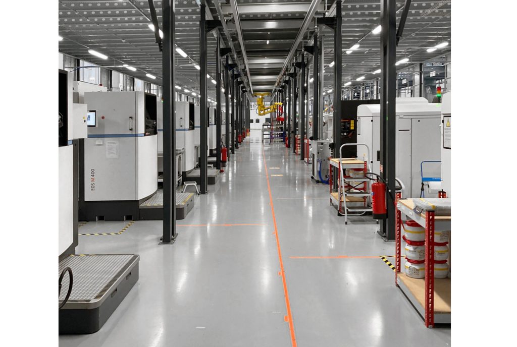 Fig. 4 A fleet of EOS M400-4 PBF-LB machines at Materials Solutions. Powder is supplied from the floor above (Courtesy Materials Solutions Ltd)