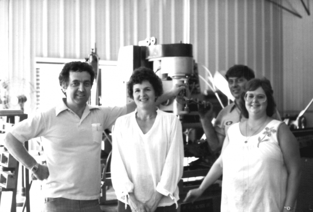 Dave and Muriel Arnold (left) stand in front of a flywheel grinder in the 1980s (Courtesy DCM Tech, Inc.)