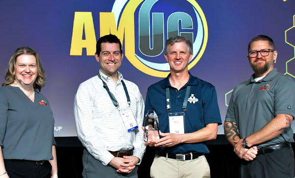 Rob Acton of Equispheres Inc. (centre left) and Steve Geddes of Martinrea International (centre right) accepting the Advanced Concepts award from Bonnie Meyer (left) and Corey Wardrop (Courtesy AMUG)