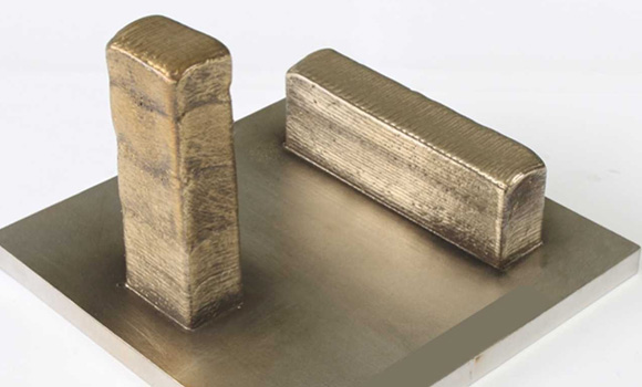 Tensile samples produced in horizontal and vertical specimen blocks (Courtesy Müller, Vinzenz, et al, Recycling nickel aluminium bronze grinding chips to feedstock for Directed Energy Deposition via impact whirl milling: Investigation on processability, microstructure and mechanical properties, Additive Manufacturing)