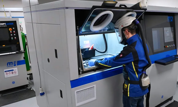 Croom Medical’s Additive Manufacturing engineer operating the Colibrium Additive M2 Series 5 machine, home to the TALOS platform (Courtesy Croom Medical)