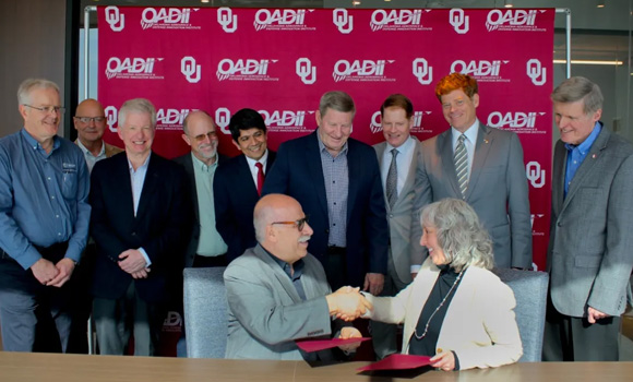 Moe Khaleel, associate laboratory director, National Security Sciences, Oak Ridge National Laboratory, shakes hands with Carol L Silva, interim vice president for research and partnerships, University of Oklahoma, during the signing ceremony (Courtesy ORNL)