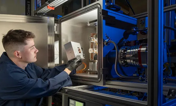 Matthew Deans of the James Watt School of Engineering loads a cartridge of additively manufactured samples into the NextSpace TestRig for testing (Courtesy University of Glasgow)