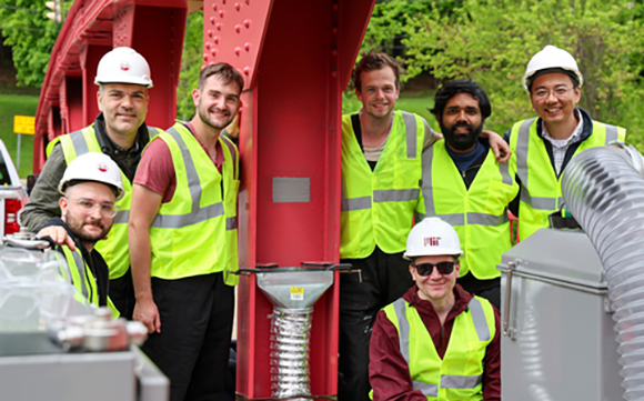 Members of the UMass Amherst and MIT Department of Mechanical Engineering research team, led by Simos Gerasimidis (left, standing) with the additively manufactured patch (Courtesy University of Massachusetts Amherst)