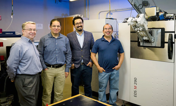 (Left to right) Dr Ibrahim Karaman, Dr Alaa Elwany, Dr Mohsen Taheri Andani and Dr Raymundo Arroyave next to an Additive Manufacturing machine (Courtesy Texas A&M)