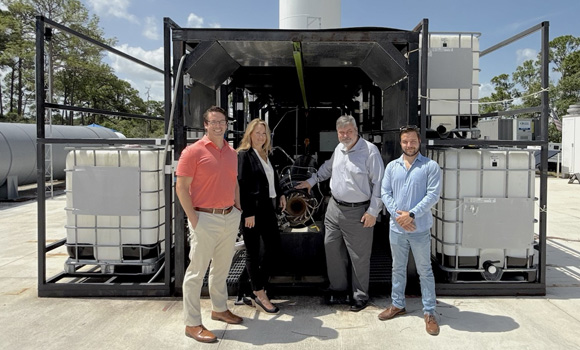 Vayaa Space Lead Propulsion Engineer Kineo Wallace and COO Rob Fabian on Vaya’s hot fire test pad with Brice Cooper, VP of Defense, and Michelle Sidwell, CRO of Velo3D (Courtesy Velo3D)