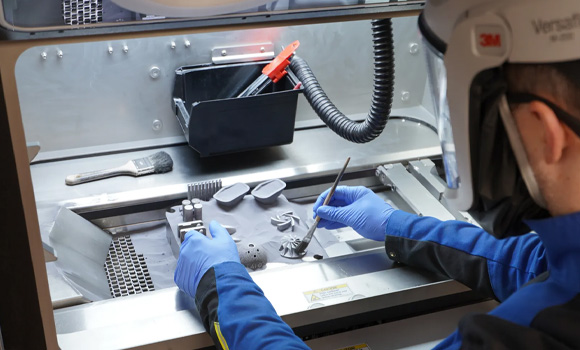 Unloading tantalum components from Croom Medical’s TALOS AM platform (Courtesy Croom Medical)