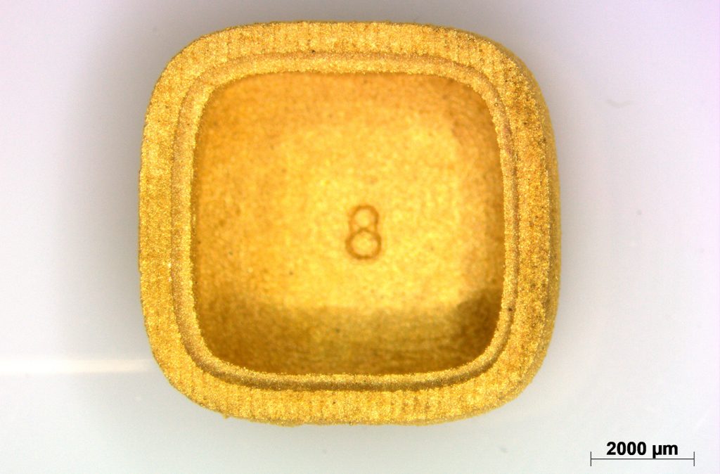 Fig. 11 Top view of a pickled yellow-precious-metal test coupon with square recess, optical micrograph at 8x magnification (scale bar 2,000 µm) (Courtesy Nora Lecis)