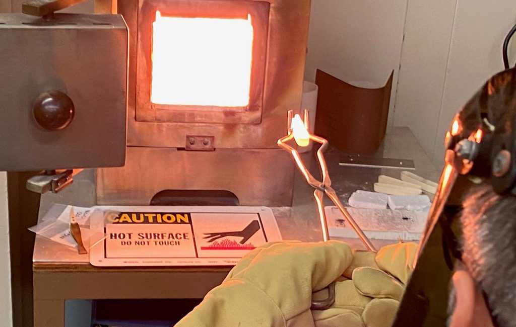 Fig. 11 Removing a thermally cycled specimen from a high‑temperature furnace at 1,300°C (Courtesy NASA)