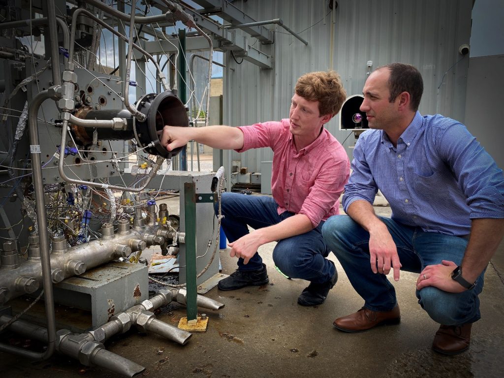 Fig. 16 NASA’s Darren Tinker (left) and Tim Smith (right) with a GRX-810 rocket engine (Courtesy NASA)