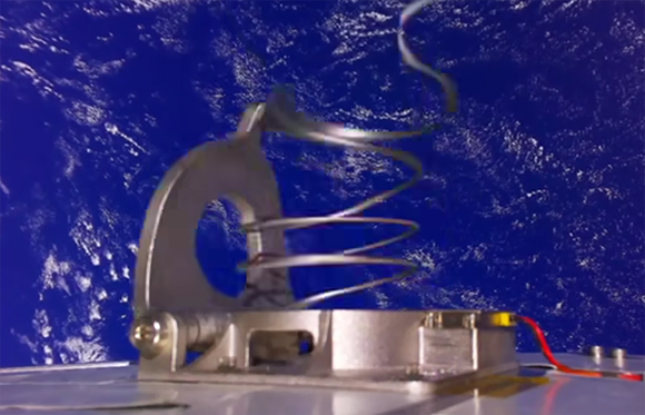 The titanium deployment spring within the JPL Additive Compliant Canister (JACC), showcasing the embedded mechanism architecture enabled by Additive Manufacturing (Courtesy Proteus Space)