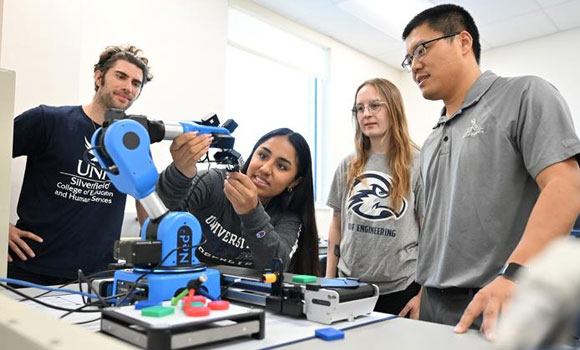 Dr Longfei Zhou (right) observing students working on a 3D project (Courtesy University of North Florida)