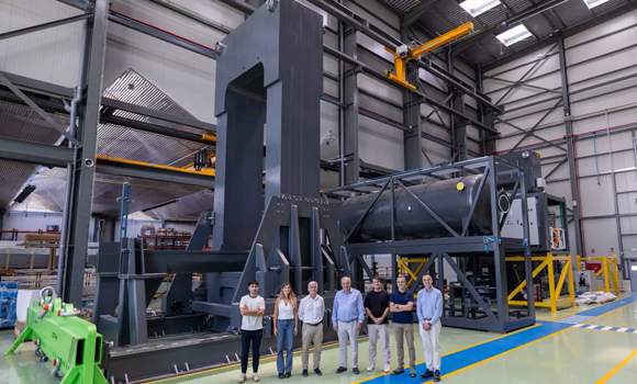 Representatives of Hiperbaric and TTT Group standing in front of a HIP 107 unit under construction (Courtesy Hiperbaric)