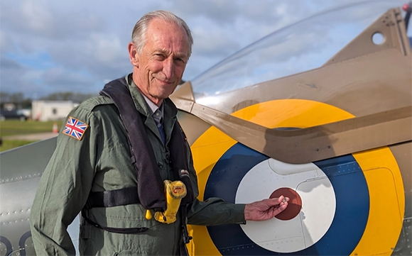 Bill Hopkins, co-founder of Phoenix Scientific Industries and a trained pilot, pictured with a Spitfire. PSI worked on a project to atomise material from the engine cowling of a Mk-XVI Spitfire for use in commemorative gold coins (Courtesy Phoenix Scientific Industries)