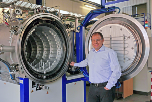 MUT founder Heinz-Jürgen Blüm with one of the company’s debind and sinter furnaces (Courtesy MUT Advanced Heating GmbH)