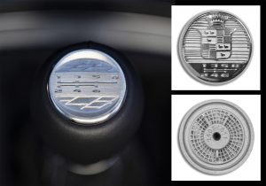 Fig. 7 A metal additively manufactured shifter emblem for the Cadillac Blackwing V-series, produced in stainless steel by Binder Jetting. Top right inset shows a design variant, easily achievable with AM, whilst lower right shows the heat dissipating design on the part's rear (Courtesy General Motors)