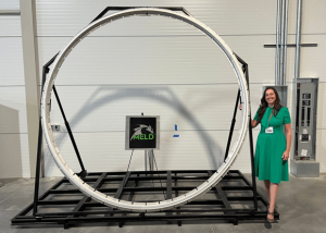 Nanci Hardwick, MELD CEO, with the additively manufactured 3 m tall MELD deposited ring which was showcased at the facility ribbon-cutting ceremony (Courtesy MELD Manufacturing Corporation)