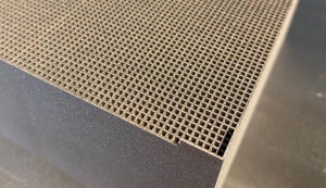 The tungsten modules, with around 5000 square holes measuring 1.2 x 1.2 x 150 mm are manufactured using the AMCM M 290-2 FDR Additive Manufacturing machine (Courtesy AMCM/CERN)