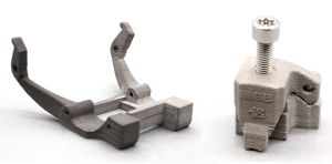 Zetamix’s 316L filament is undergoing beta testing for helmet brackets (left) and lubrication nozzles (right) (Courtesy Nanoe)