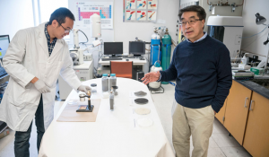 Zak Fang (right) and Pei Sun, research associate in the Powder Metallurgy Research Lab (left) describe the process to reduce commercial titanium dioxide into the final pure titanium powder (Courtesy The University of Utah)