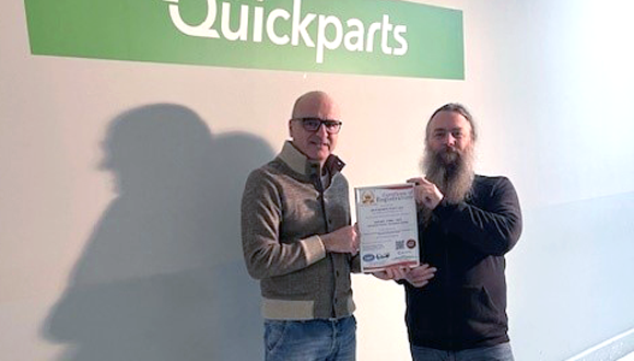 Marco Maio (L), Director of Operations, Europe and Shawn Pearson (R), IT Manager for Europe display the ISO27001:2022 certificate awarded to Quickparts Italy SRL (Courtesy Quickparts)